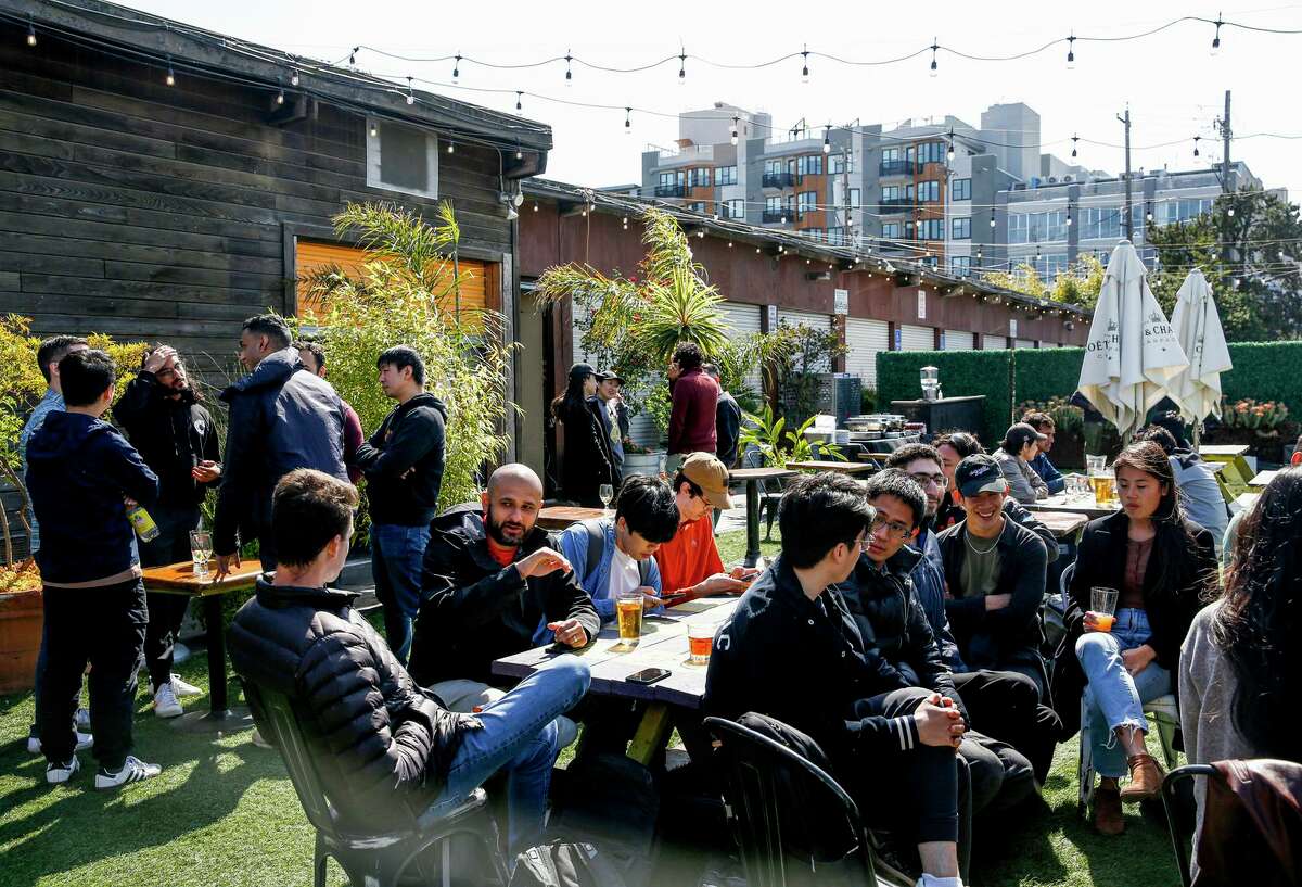 Customers gather in the outdoor patio at The Ramp restaurant in San Francisco on Sunday. The port is threatening to evict the restaurant and the adjacent boat yard over a lease dispute.