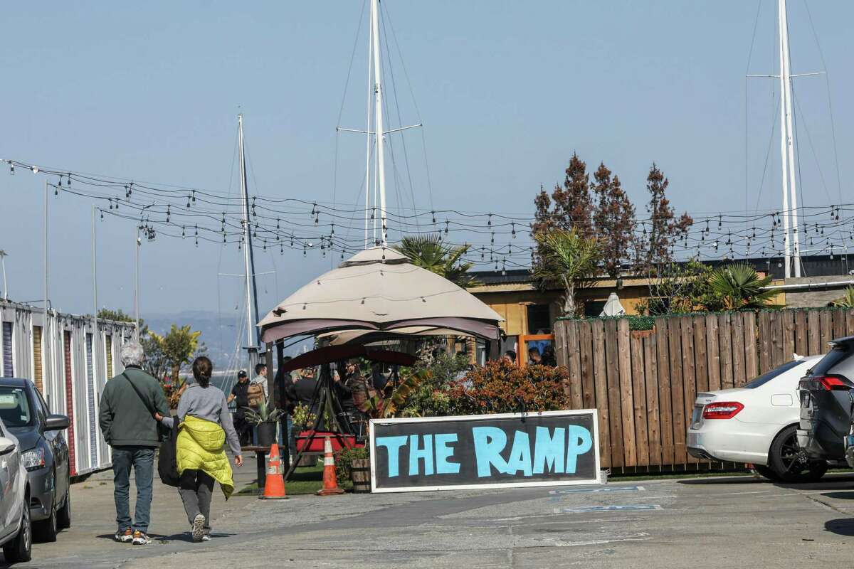 A sign directs customers to The Ramp restaurant in San Francisco, Calif. on Sunday, May 1, 2022. The port of San Francisco is threatening to evict the restaurant and the adjacent boat yard.