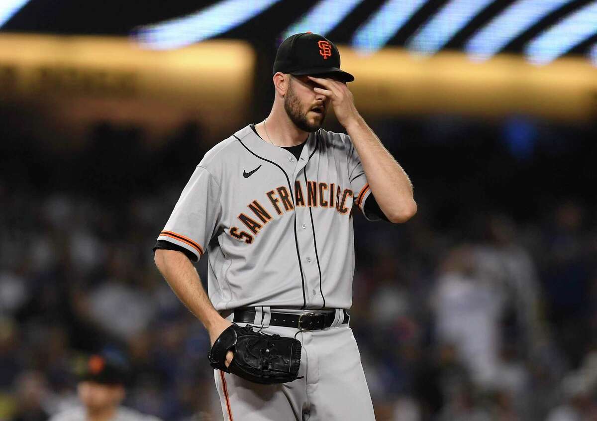 LOS ANGELES, CA - MAY 04: Starting pitcher Alex Wood #57 of the San Francisco Giants reacts after giving up a base hit to Trea Turner #6 of the Los Angeles Dodgers to score Mookie Betts #50 during the fourth inning at Dodger Stadium on May 4, 2022 in Los Angeles, California. (Photo by Kevork Djansezian/Getty Images)