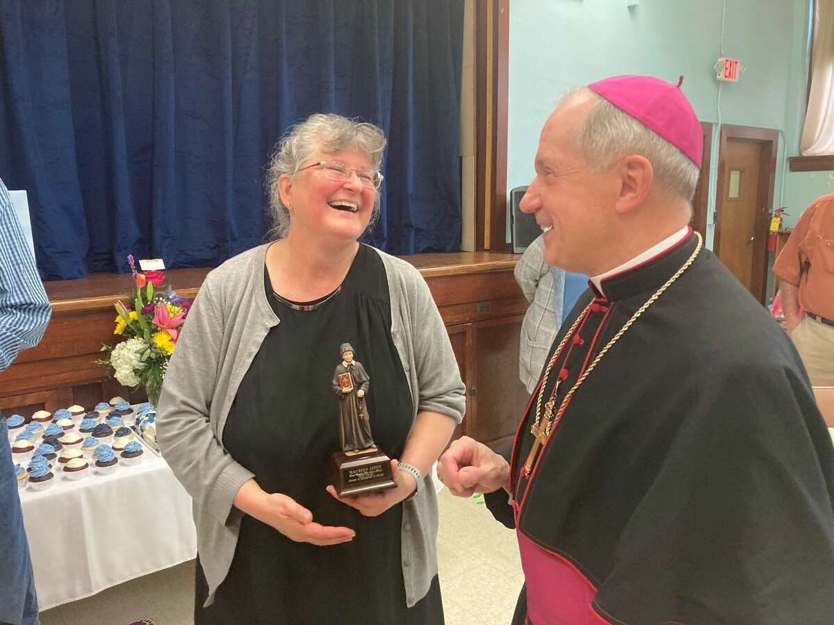 Maureen Tepen of St. Mary Catholic School in Brussels is congratulated by Bishop Thomas John Paprocki for her selection as the recipient of this year's St. Elizabeth Ann Seton Award honoring teaching excellence. 