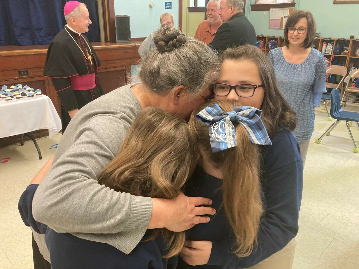 Maureen Tepen is embraced by her students at St. Mary Catholic School in Brussels after being named the Diocese of Springfield's 2022 winner of the St. Elizabeth Ann Seton .
