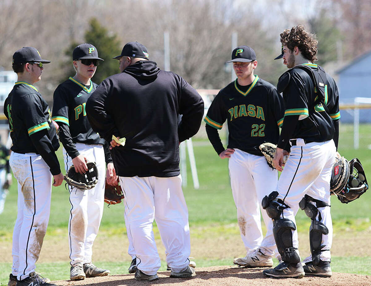 Southwestern coach Brian Hanslow meetswith his Piasa Birds on the mound during a pitching visit in a game earlier this season in Brighton, On Wednesday in Alton, the Birds won their sixth in a row by beating Marquette at Hopkins Field.