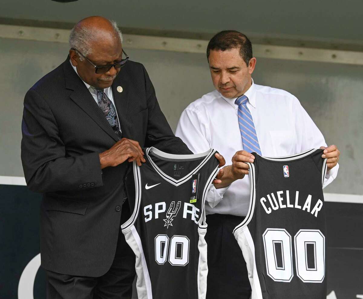 U.S. Rep. Henry Cuellar, D-Laredo, right, and House Majority Whip James E. Clyburn look at their gifted Spurs jerseys during a campaign rally at the Smoke BBQ+SKYBAR in San Antonio on Wednesday, May 4, 2022. Cuellar is defending his longtime South Texas congressional seat against progressive challenger Jessica Cisneros. Cuellar is facing renewed scrutiny from fellow Democrats over his anti-abortion stance following news that the U.S. Supreme Court appears poised to overturn Roe v. Wade.