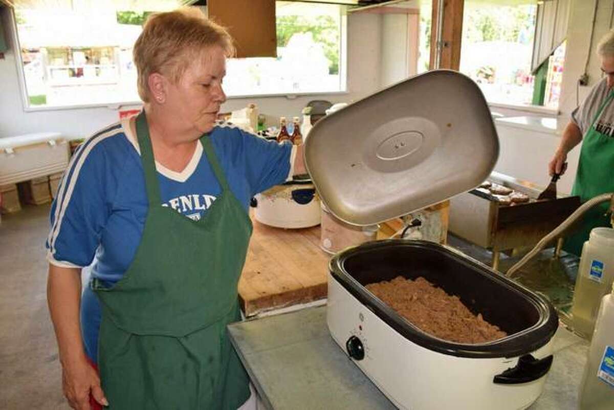 Crystal Calvert checks Italian beef while it’s cooking at the annual Italian-American Days Festival in 2018. After a two-year absence, the Benld festival will return May 27-29.