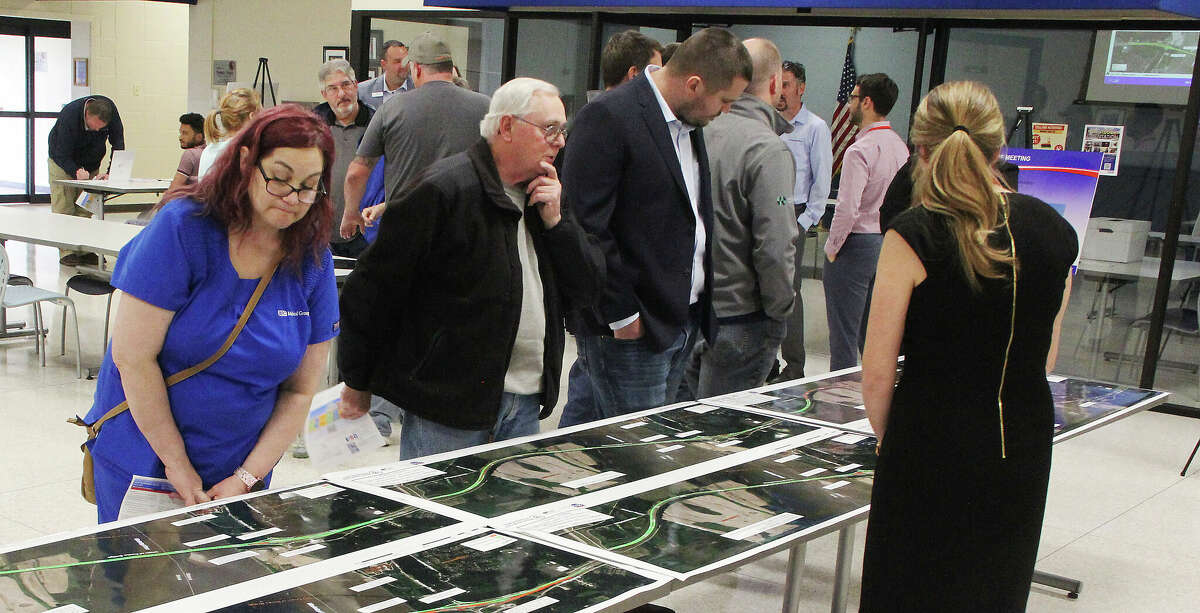 People look at displays showing traffic patterns during different phases of construction during a public meeting Wednesday on the new I-270 Chain of Rocks Bridge. The meeting was held at the Southwestern Illinois College's Granite City Campus, and was intended to give people information about traffic patterns during construction, which could begin as soon as this fall.