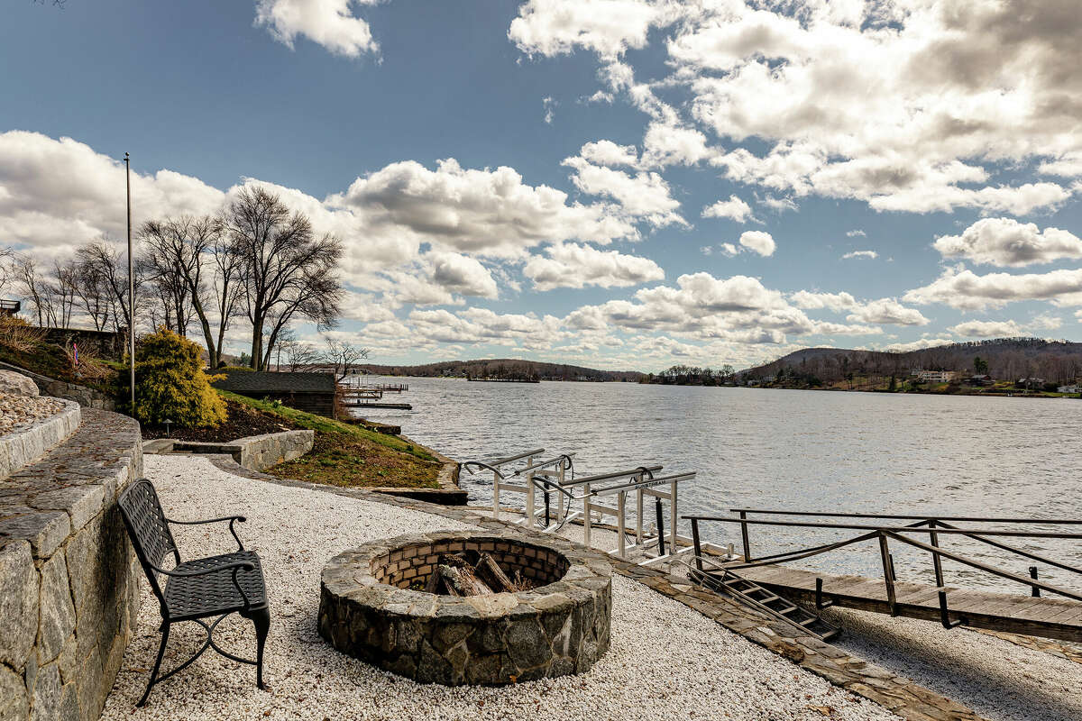 The home on 68 South Lake Shore Drive in Brookfield, Conn. has a fire pit and seating area near Candlewood Lake.