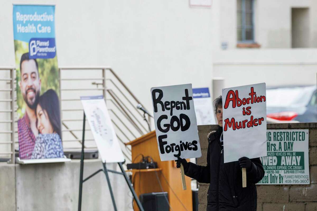 An antiabortion protester demonstrates Monday before a press conference in San Jose on funding for abortion services.