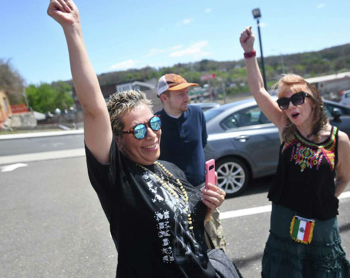 Mexico native and Derby resident Maria Gomez, left, and Derby Cultural Commission Chair Susan Lanzaro-Schroeder celebrate the raising of the Mexican flag in celebration of Cinco de Mayo outside City Hall in Derby, Conn., on Thursday, May 5, 2022.