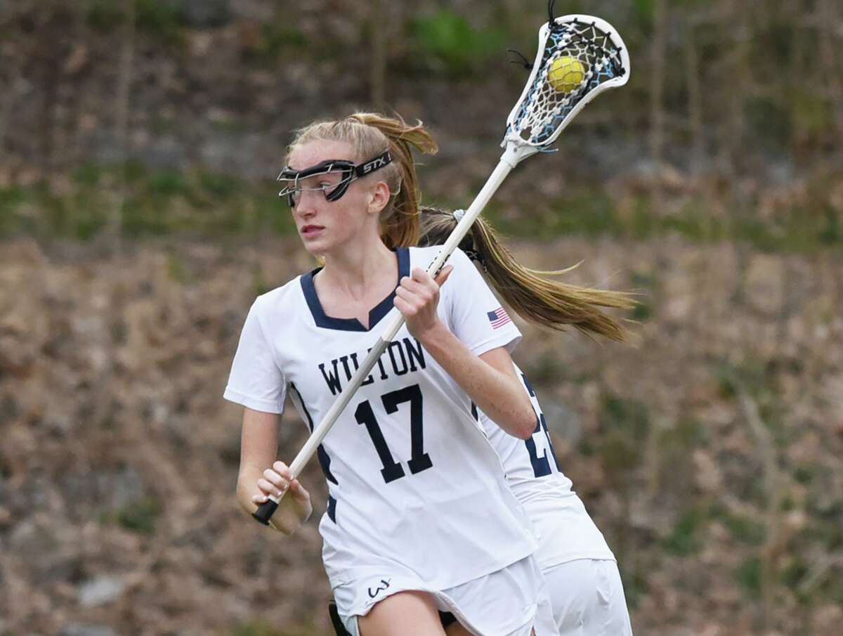 Wilton’s Molly Snow runs the offense against New Canaan on April 13.