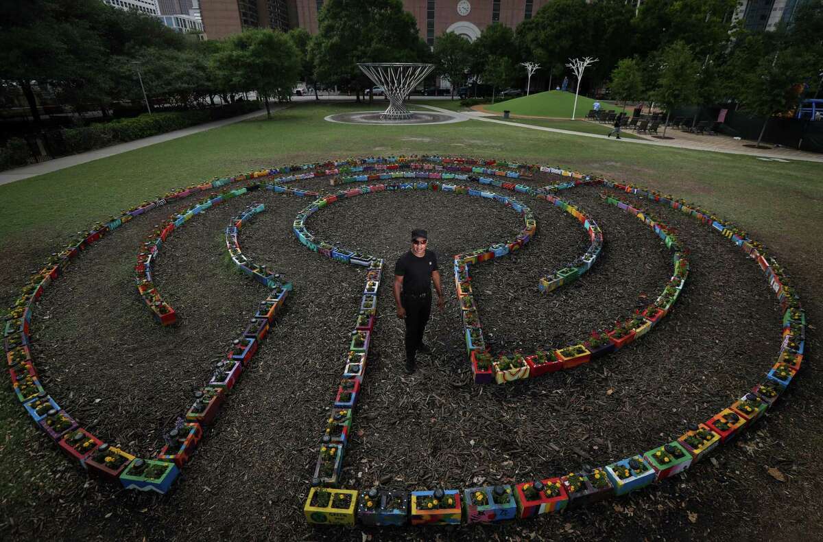Artist Reginald C. Adams poses for a portrait in a labyrinth he created Tuesday, May 3, 2022, at Discovery Green in Houston.