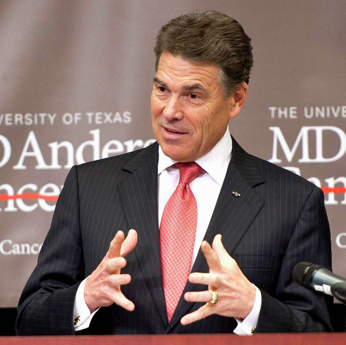 In this Nov. 28, 2011 file photo, Republican presidential candidate, Texas Gov. Rick Perry speaks in Houston. Rick Perry, though defending in-state tuition for illegal immigrants’ kids, campaigns with a hardline Arizona sheriff.