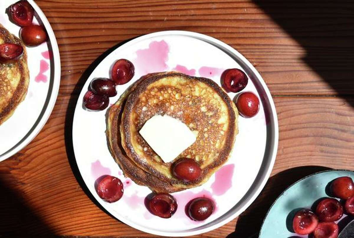Sugared cherries add flavor bombs to these tangy yogurt pancakes.