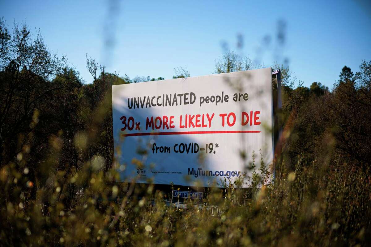 A sign advocates COVID vaccination along Highway 49 in California’s Tuolumne County. Nine of every 10 people who died in the county were not vaccinated.