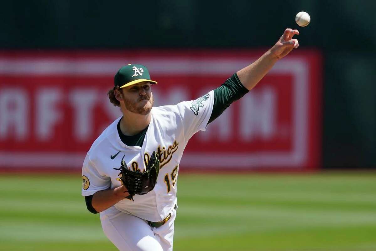 Oakland Athletics' Cole Irvin pitches against the Texas Rangers during the first inning of a baseball game in Oakland, Calif., Sunday, April 24, 2022. (AP Photo/Jeff Chiu)