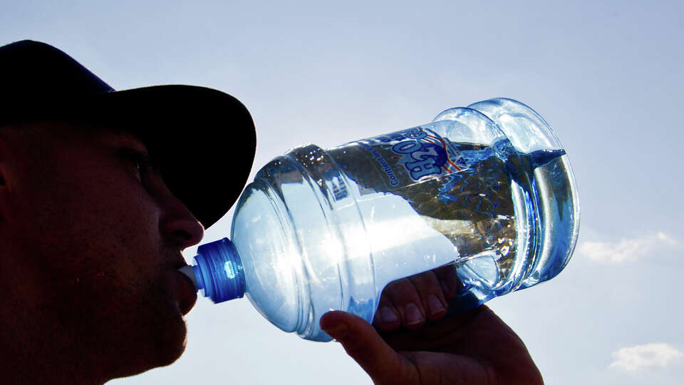 Chris Dusablon gets a drink of water as he takes batting practice at Alexander Deussen Park on Lake Houston, Saturday, Aug. 27, 2011, in Houston. Temperatures in Houston could reach record-breaking highs on May 7, 2022. 