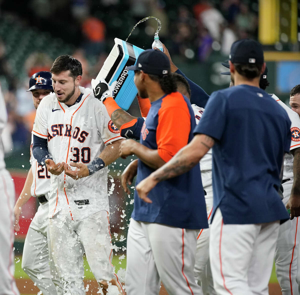 Houston Astros Kyle Tucker (30) gets an ice bath from teammates after he hit an RBI single which scored the game wining run during the ninth inning of an MLB baseball game at Minute Maid Park on Thursday, May 5, 2022 in Houston.