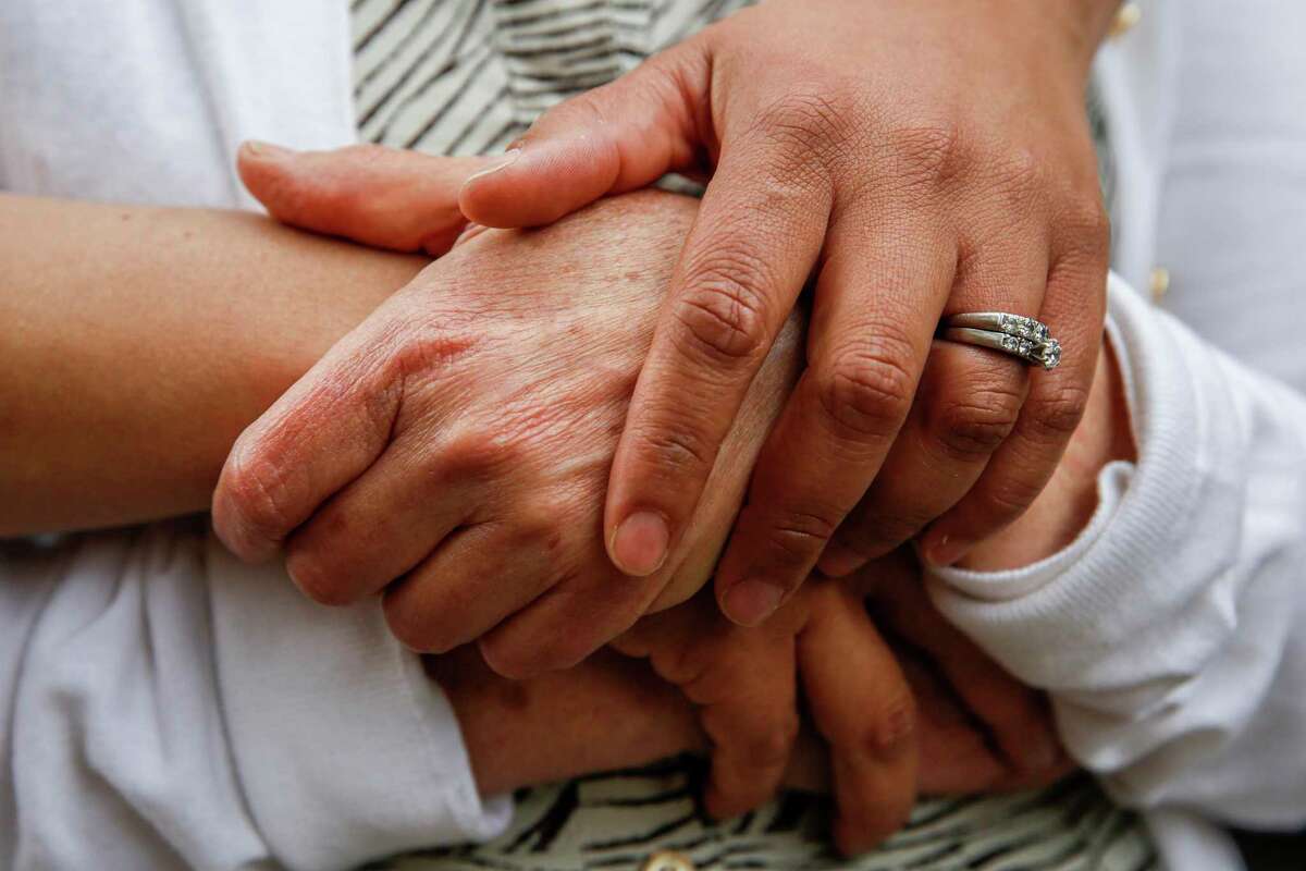 The hands of Wendy Bloom and her daughter Sarah Hallinan embrace at Sarah’s home in Berkeley. In the ’70s, Bloom had an abortion as a single mother with young twins just as she was starting her first nursing job. “I was trying to get on my feet,” Bloom said. “It wasn’t the right time.”
