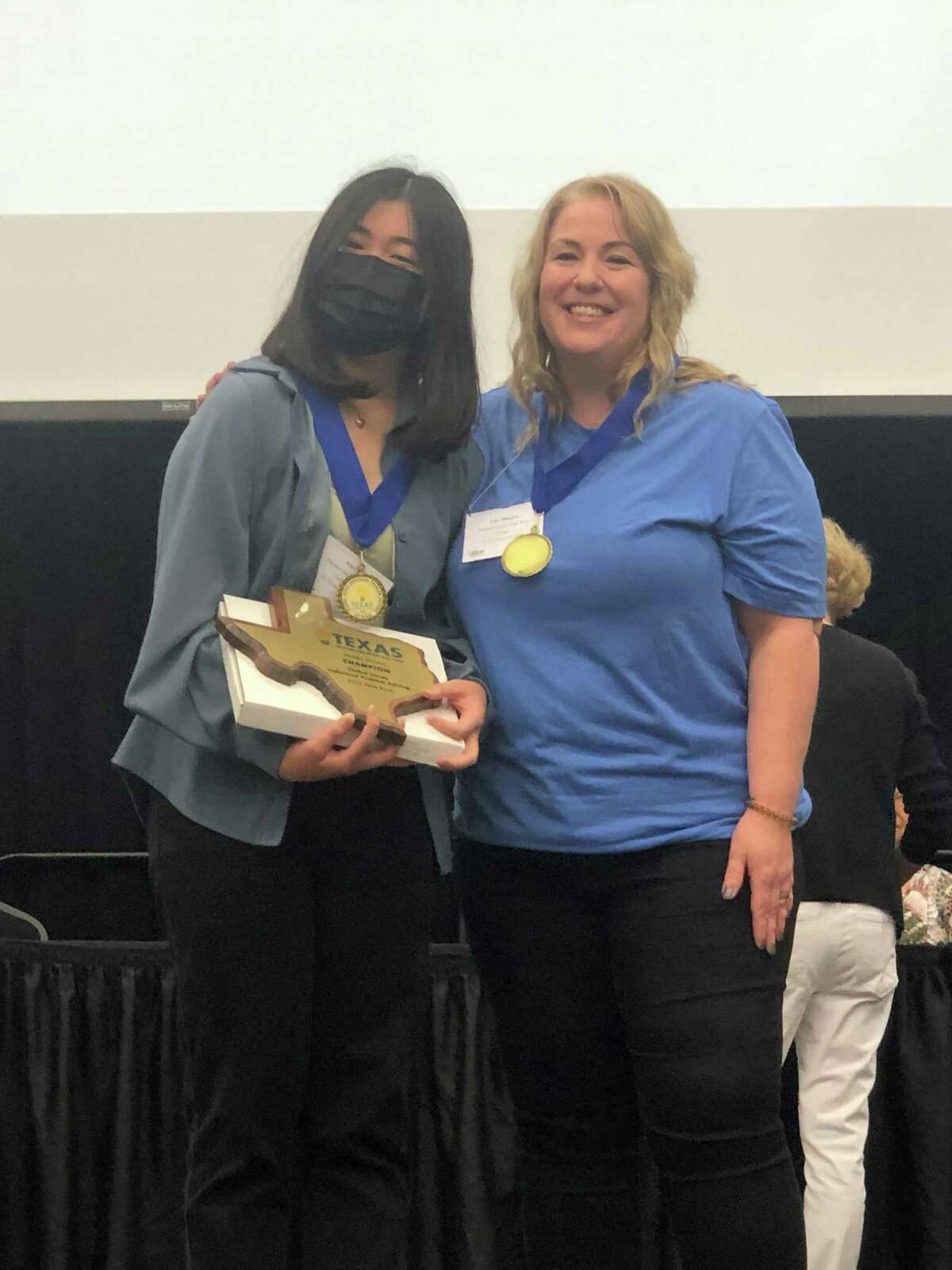 Pearland Junior High West student Kara Li, left, joins Future Problem Solving coach Lisa Shapiro after winning the individual Global Issue Problem Solving competition at State Bowl in April.