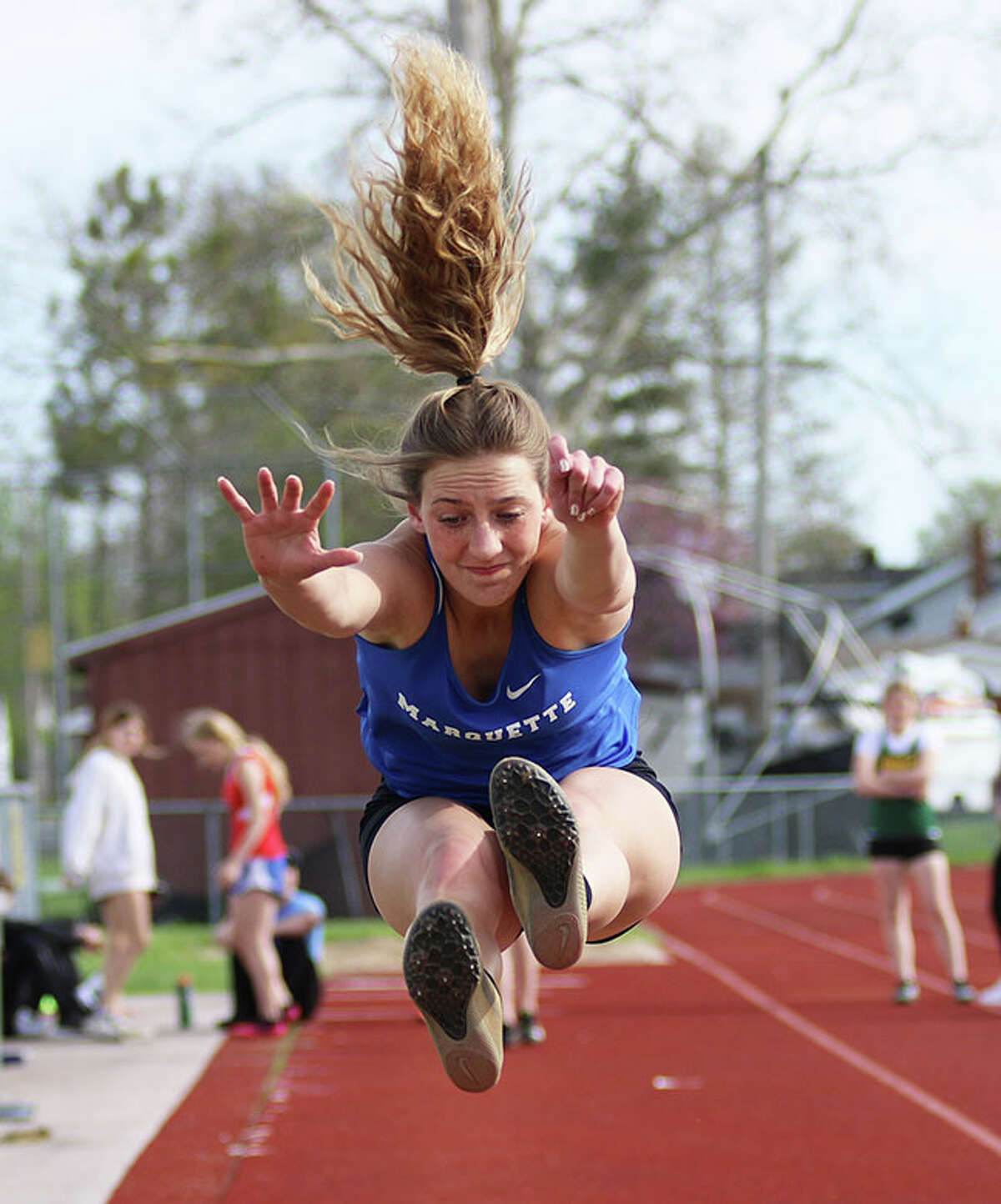 Marquette Catholic junior Sammy Hentrich competes in the long jump at last month's Madison County Meet in Wood River. On Wednesday, Hentrich won three events at the first Gateway Metro Conference Meet at Public School Stadium in Alton.