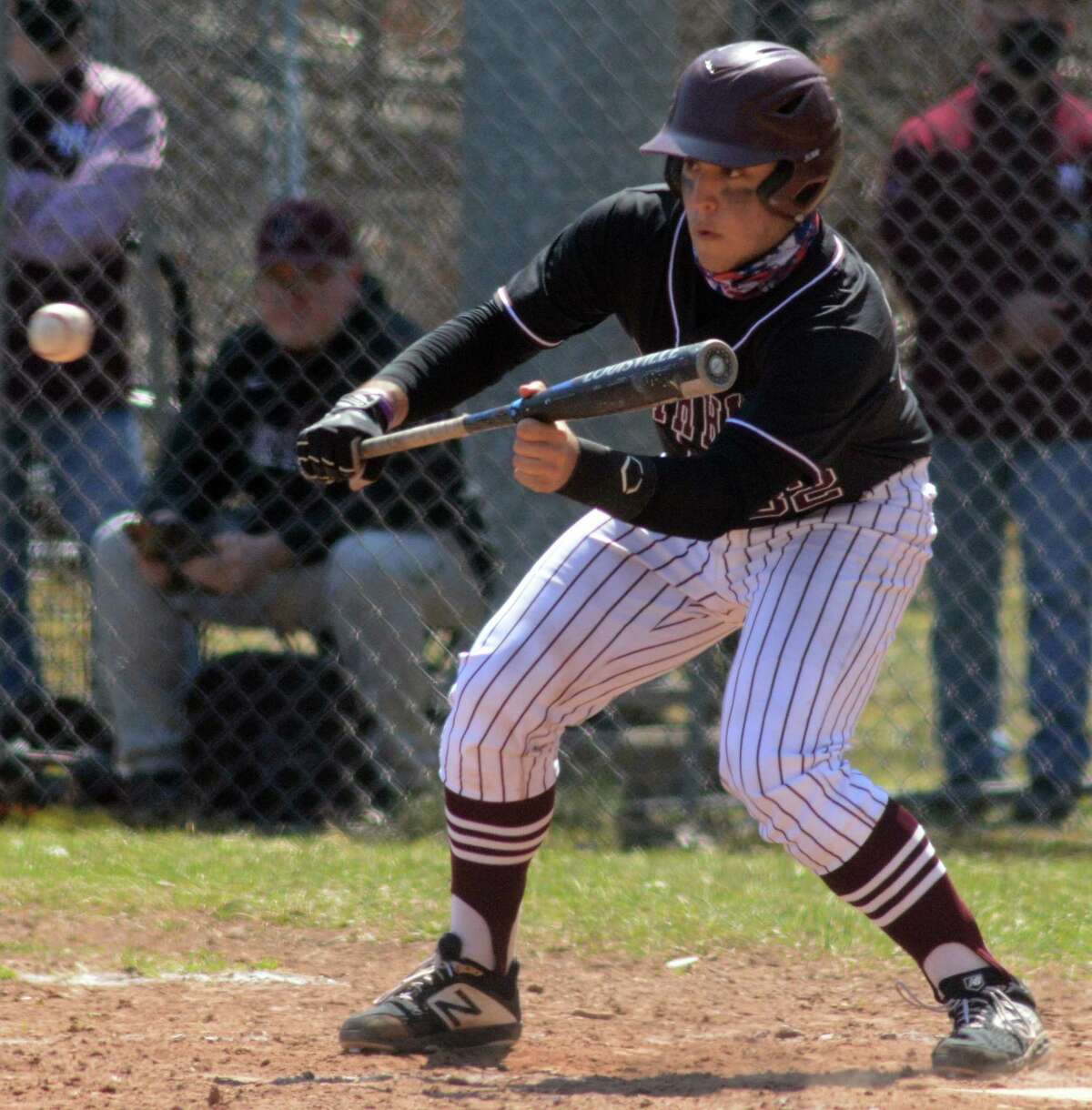 North Haven’s Anthony Acampora bunts against Guilford. High School baseball teams as bunting less and less with men on base, instead hoping for an extra-base hit to bring runners home.