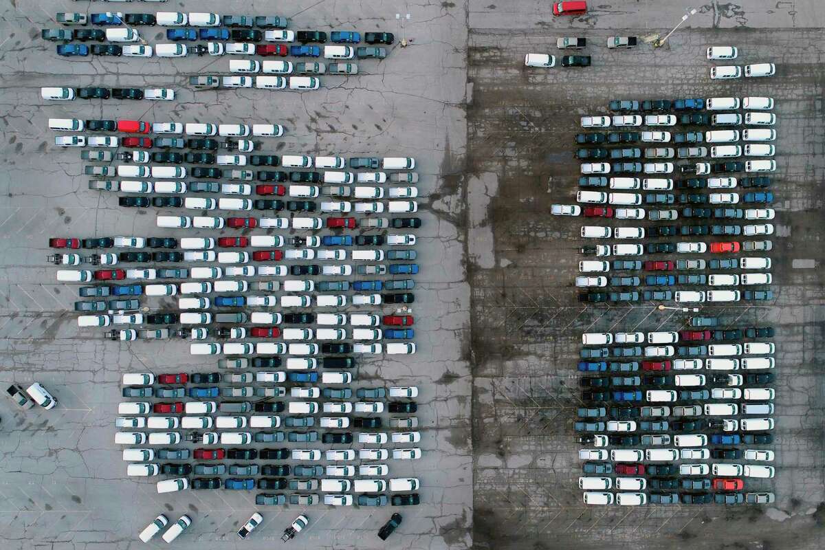 In this 2021 file photo, mid-sized pickup trucks and full-size vans are seen in a parking lot outside a General Motors assembly plant where they are produced in Wentzville, Mo. The Conroe City Council gave its purchasing department the green to order new city vehicles ahead of its 2023 budget in order to ensure departments get the vehicles needed as the global microchip shortage curbs manufacturing and limits supplies.