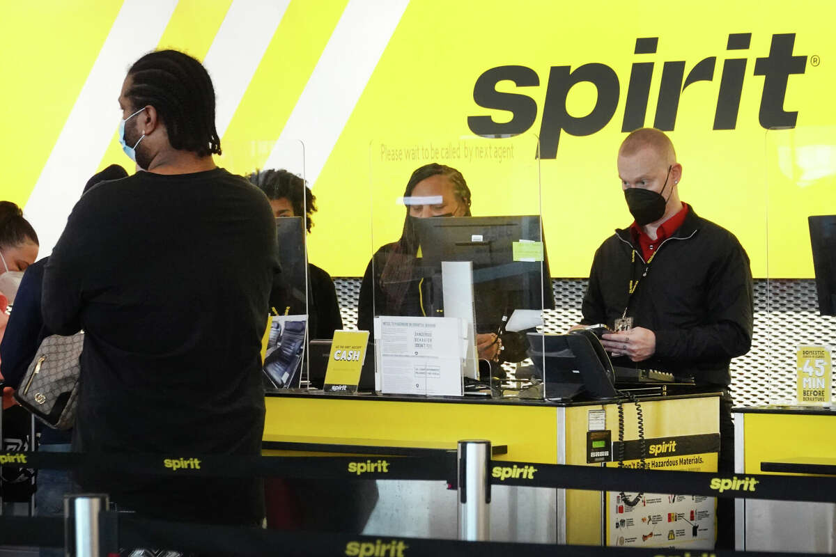 Passengers check in for flights with Spirit Airlines at O'Hare International Airport in Chicago. JetBlue Airways has made an offer to buy Spirit Airlines for $3.6 billion.