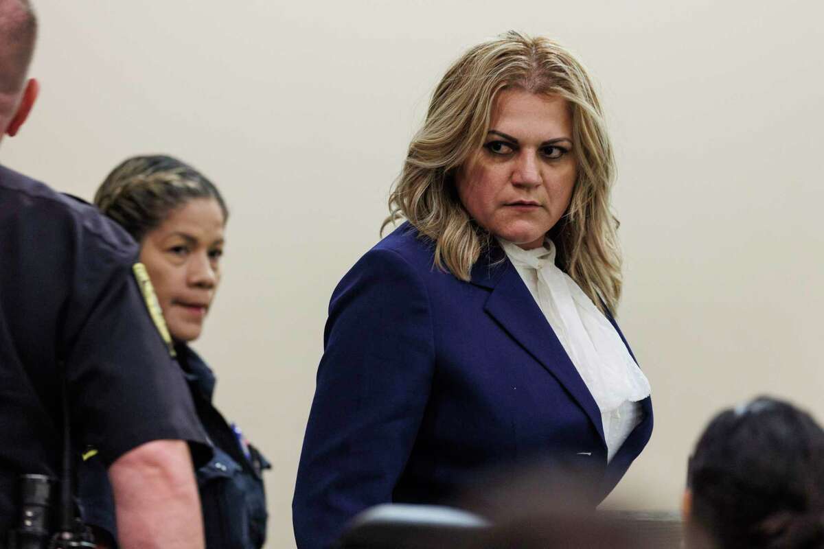 Angelica Navarro-DePaz is led back into the courtroom before the jury announces her punishment Friday. After finding her guilty Wednesday of solicitation to commit capital murder, the jury handed her a 20-year prison sentence.