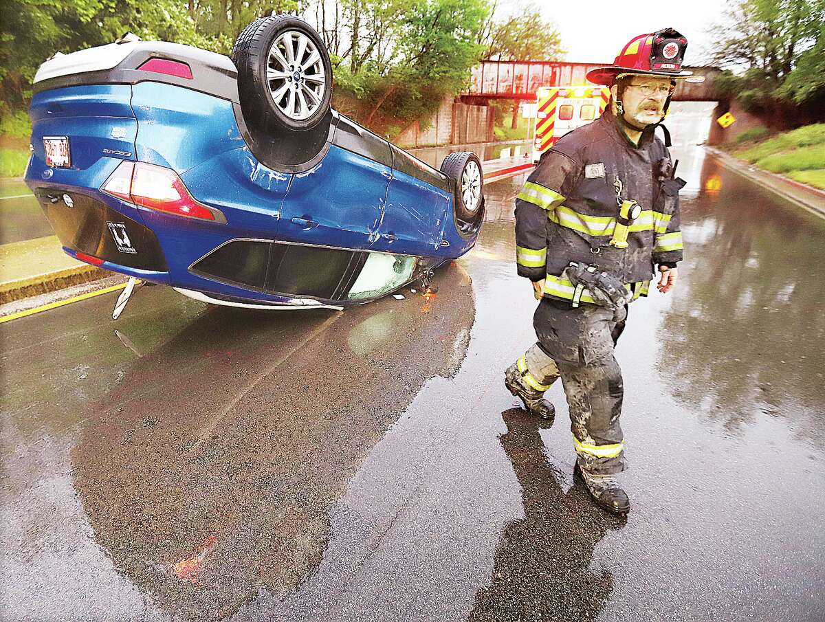 John Badman|The Telegraph A few Riverbend motorists wished the rain would go away and come another day after a number of no-injury accidents Friday. Alton firefighters were called about 6:02 a.m. Friday to the Homer Adams Parkway between Seminary Street and Washington Avenue after a motorist flipped a Ford Escape near the viaduct. The driver in the single vehicle crash was treated inside an Alton Fire Department ambulance but declined transport to a hospital. About two hours later a Buick broad-sided a Kia sedan on the rain slick roadway at the entrance to Clark Bridge about two hours later. Accidents were reported from Hartford to Hamil, but most of those involved escaped serious injuries.