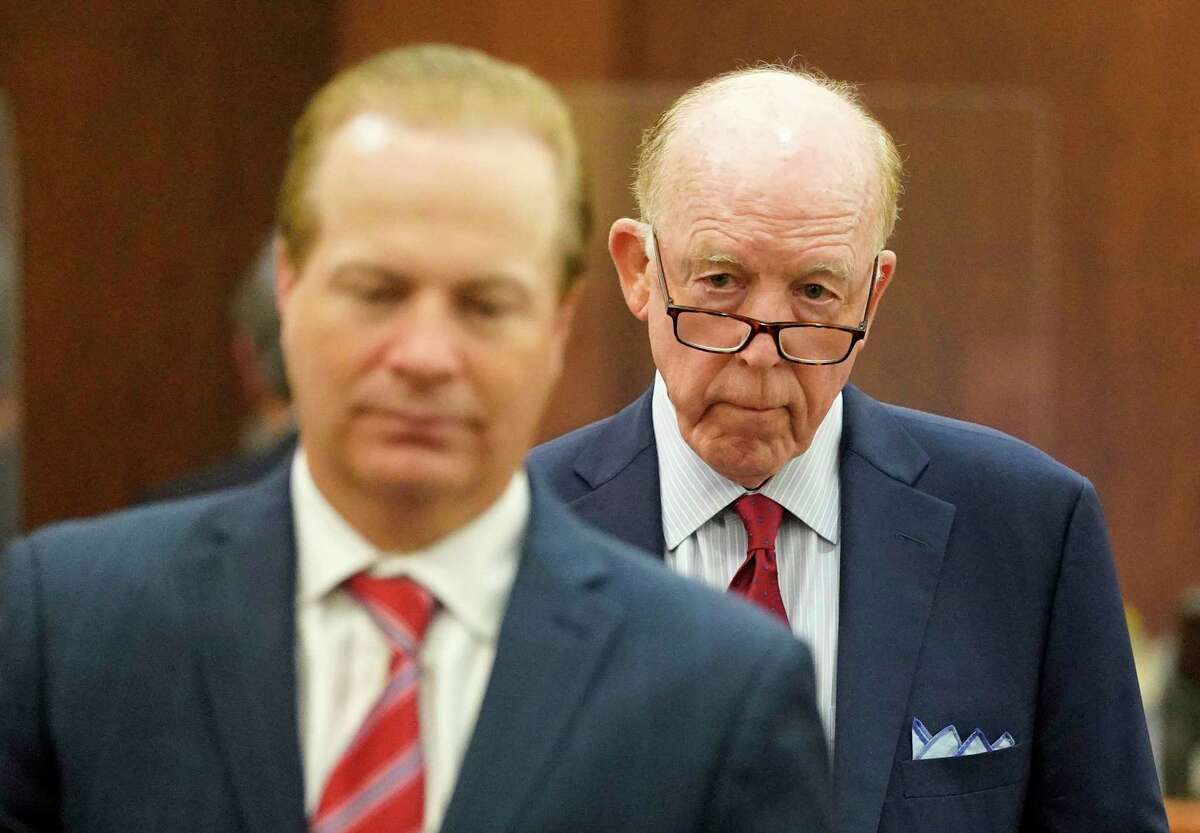 Steven Hotze, right, leaves with attorney Jared Woodfill, left, after his appearance in the 482nd District Court at the Harris <a class=