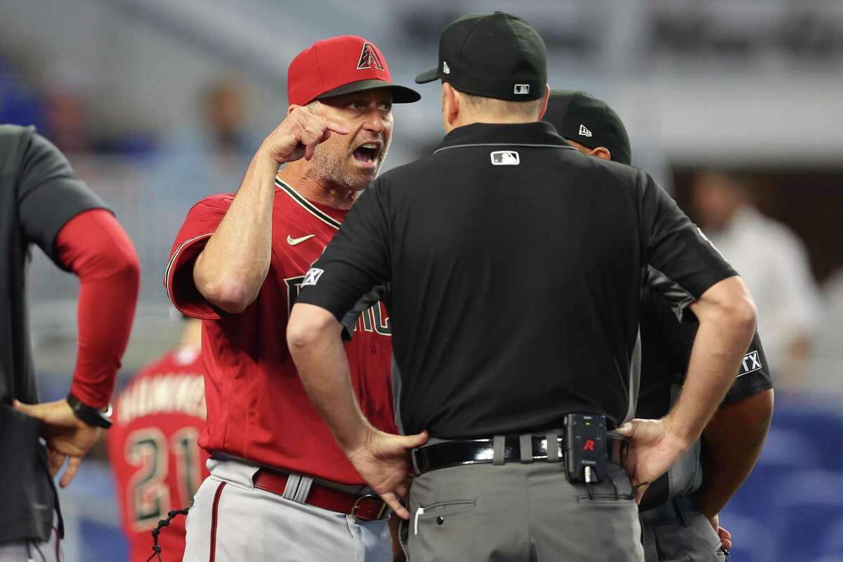 MIAMI, FLORIDA - MAY 04: Manager Torey Lovullo of the Arizona Diamondbacks argues with umpires Dan Bellino and Adrian Johnson after Madison Bumgarner (not pictured) was ejected from the game during the first inning against the Miami Marlins. (Photo by Michael Reaves/Getty Images)