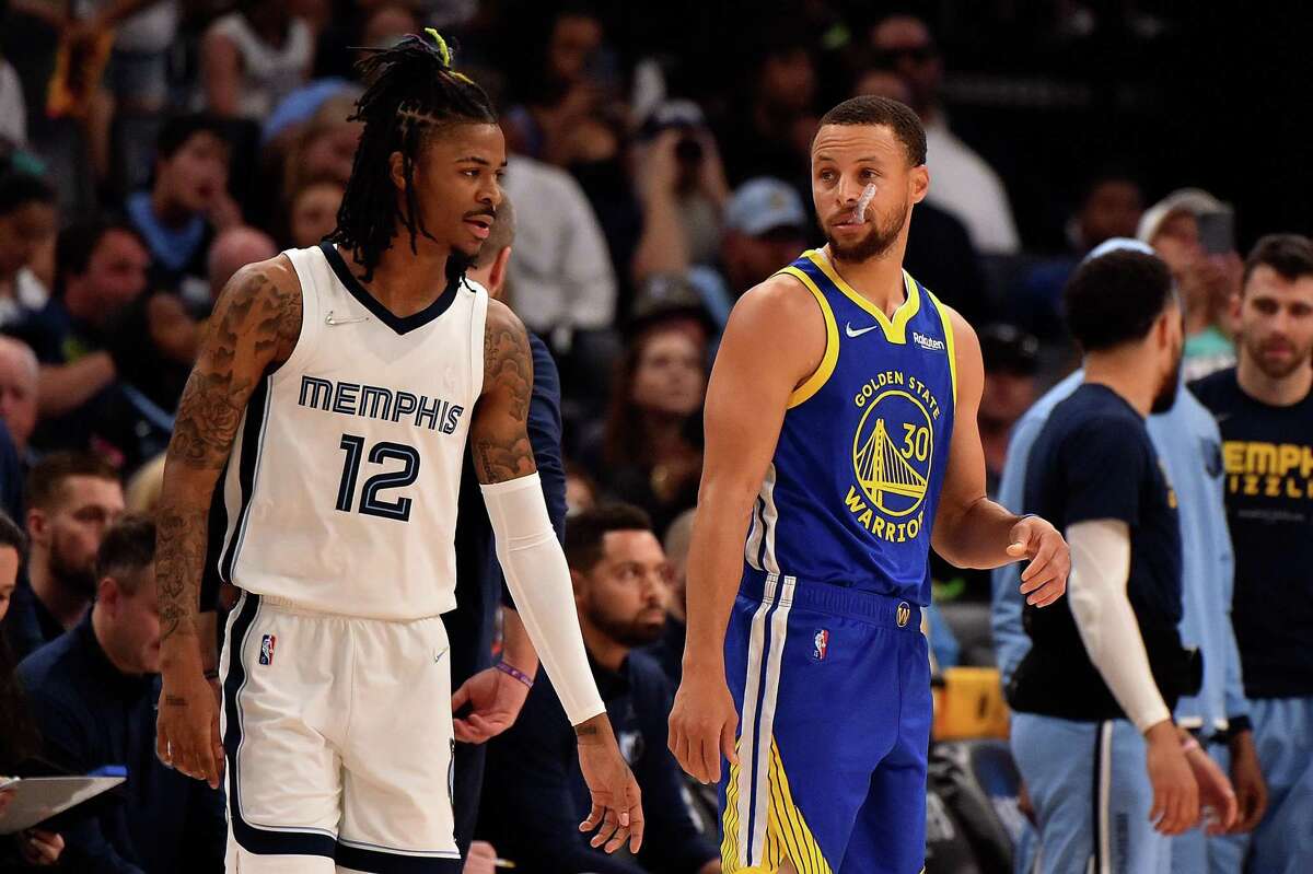 MEMPHIS, TENNESSEE - MAY 01: Stephen Curry #30 of the Golden State Warriors and Ja Morant #12 of the Memphis Grizzlies during Game One of the Western Conference Semifinals of the NBA Playoffs at FedExForum on May 01, 2022 in Memphis, Tennessee. NOTE TO USER: User expressly acknowledges and agrees that, by downloading and or using this photograph, User is consenting to the terms and conditions of the Getty Images License Agreement. (Photo by Justin Ford/Getty Images)