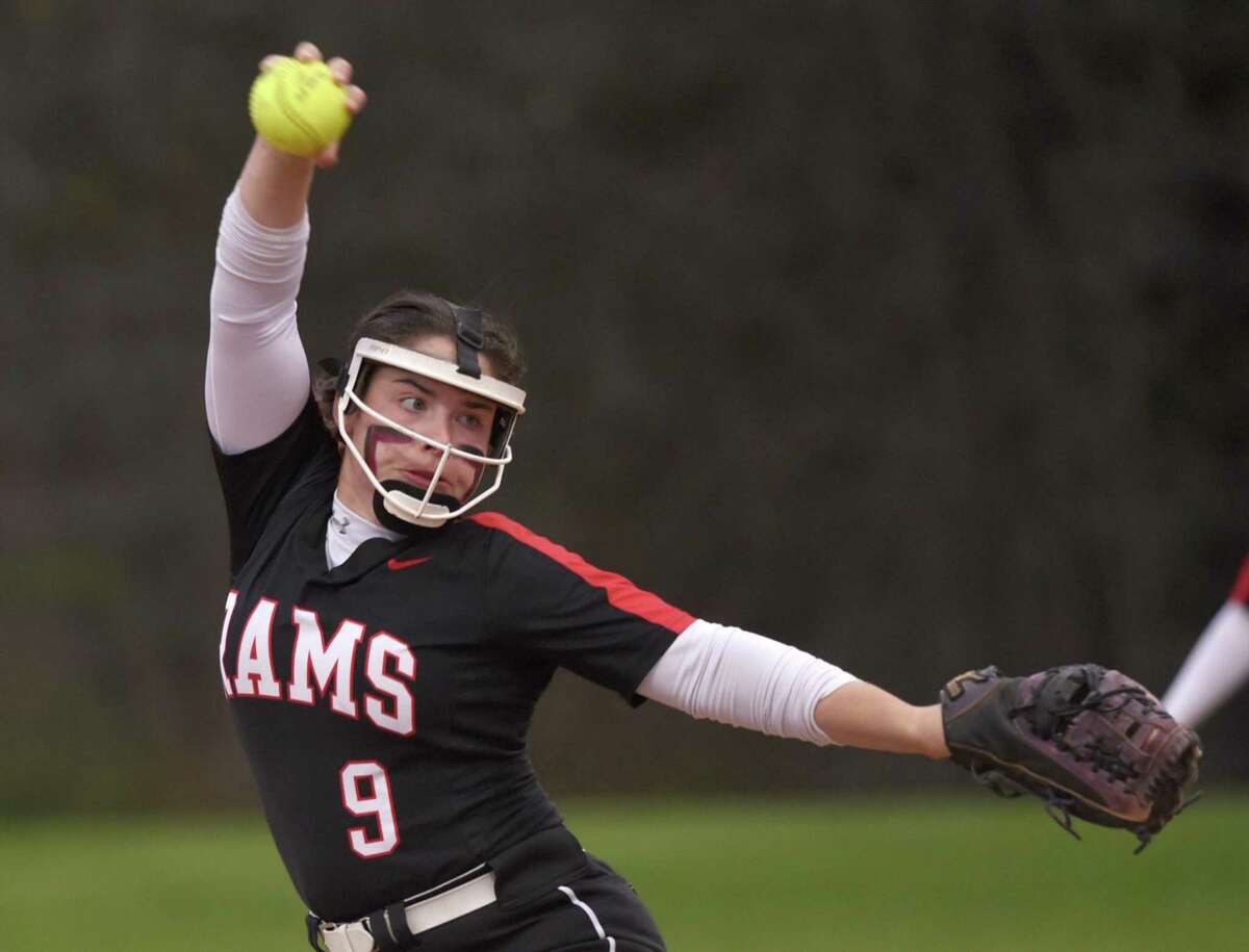 New Canaan’s Ava Biasotti fires in a pitch against Ridgefield on April 25.