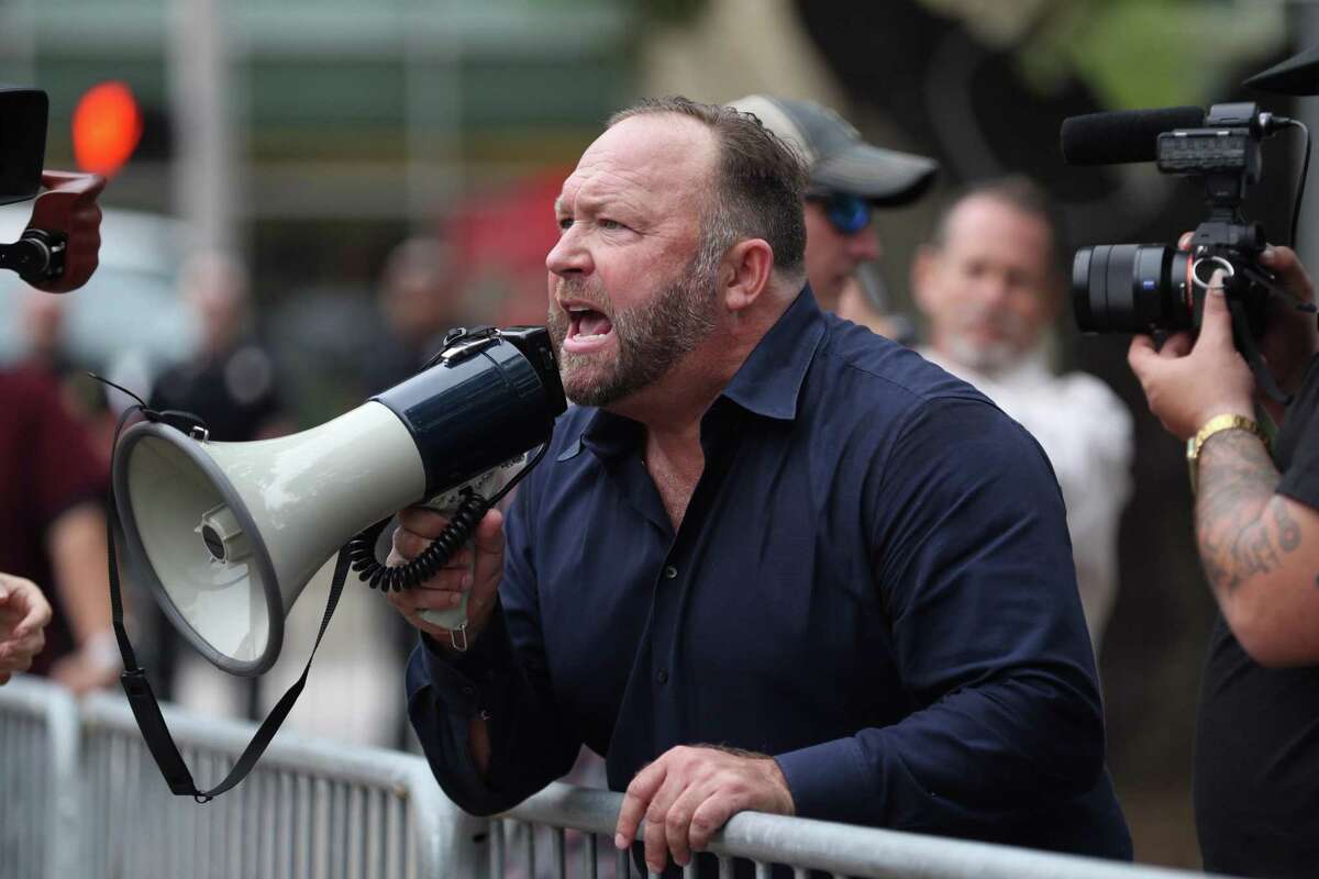 Alex Jones, of InfoWars, yells at protestors outside of Toyota Center before a Trump campaign rally, Monday, October 22, 2018, in Houston.