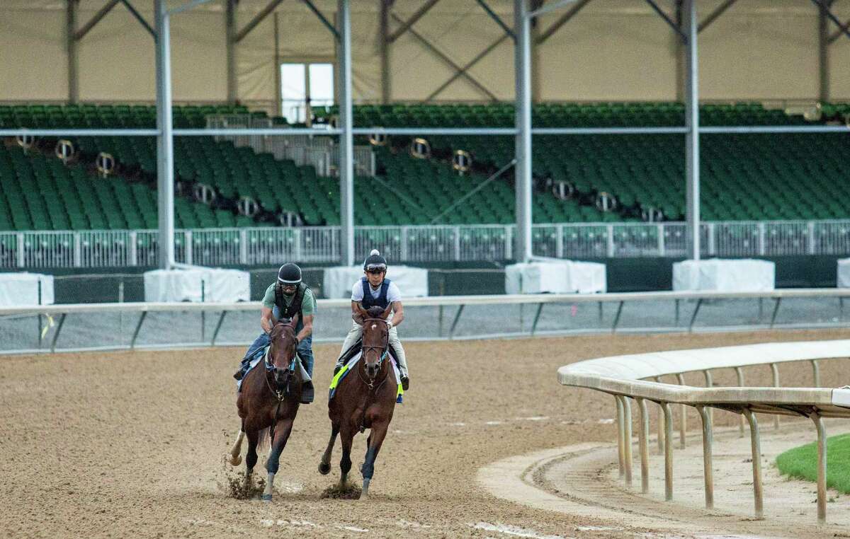 Epicenter, right, and exercise rider Wilson Fabian run five furlongs next to fellow Eddie Martin Jr. ridden Alejandro, left, at Churchill Downs in Louisville, Ky., on Sunday, May 1, 2022. Steve Hall of Fame coach Asmussen is set to finally add the Kentucky Derby to his resume with the Epicenter contender as the highlight of a career that has also involved animal abuse accusations.  (Grace Ramey/Daily News via AP)