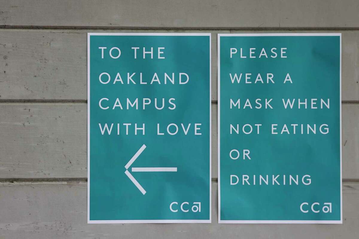 Signs give directions to the farewell for the Oakland campus of California College of the Arts.
