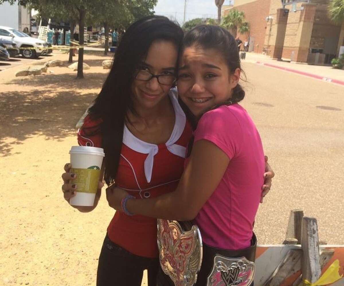 Former WWE Superstar AJ Lee pictured next to 13-year-old Carla Gonzalez outside of Laredo Energy Arena in 2015. Gonzalez, ring name Roxanne Perez, signed with WWE in March 2022 and credits AJ Lee for being her inspiration.