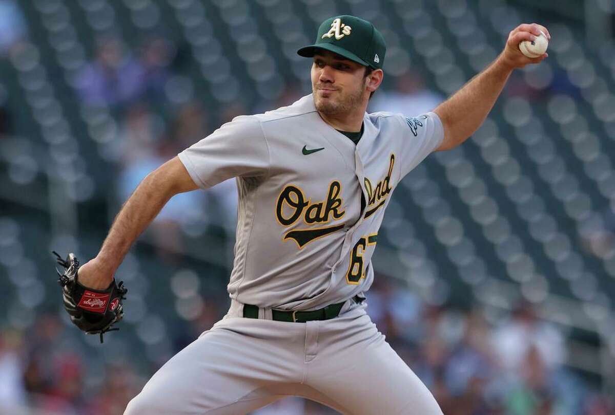 Oakland Athletics pitcher Zach Logue throws to a Minnesota Twins batter during the first inning of a baseball game Friday, May 6, 2022, in Minneapolis. (AP Photo/Stacy Bengs)