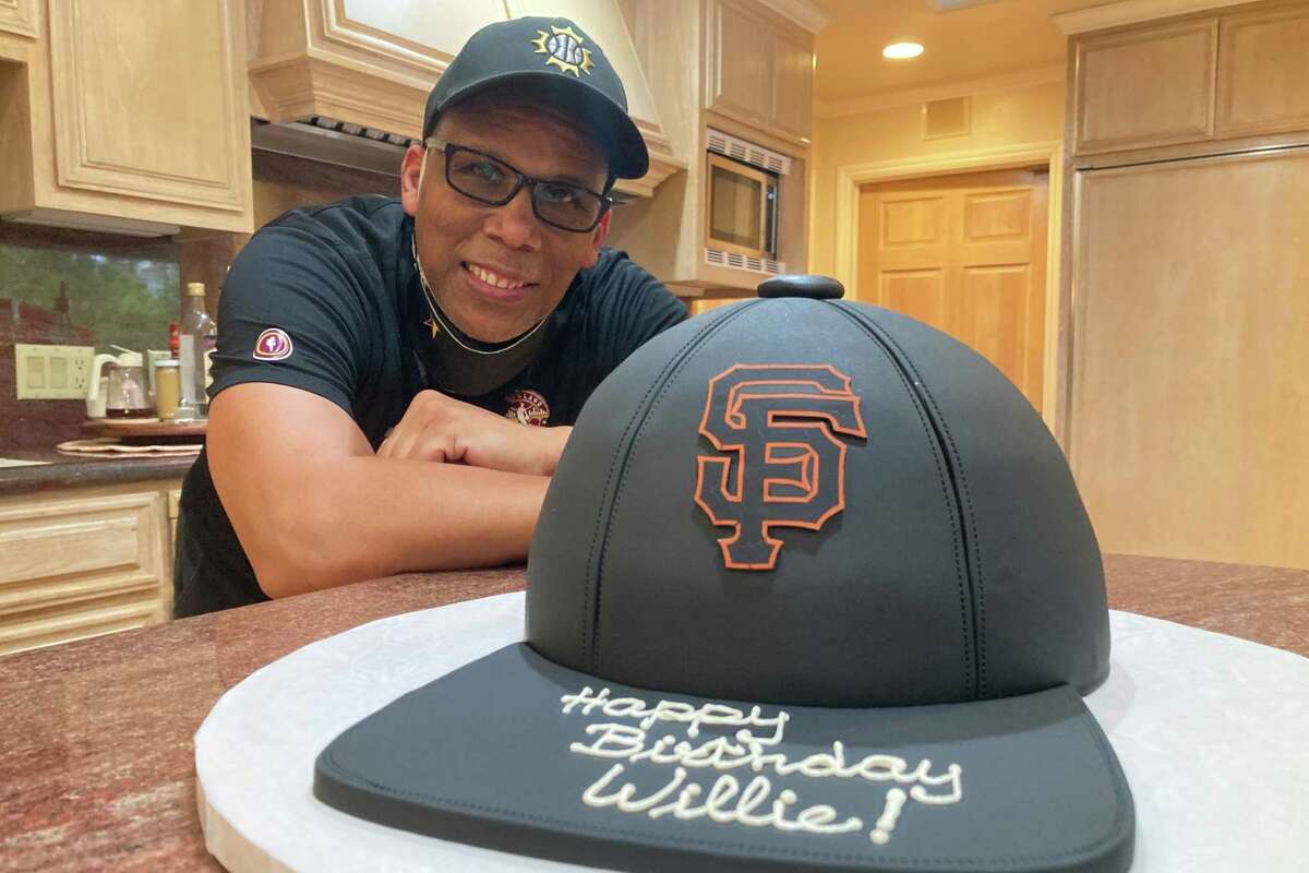 Daniel Murphy of San Mateo poses with Willie Mays’ 91st birthday cake at Mays’ home Friday night. Murphy gets the Say Hey Kid’s cake every year, always picking a different theme.