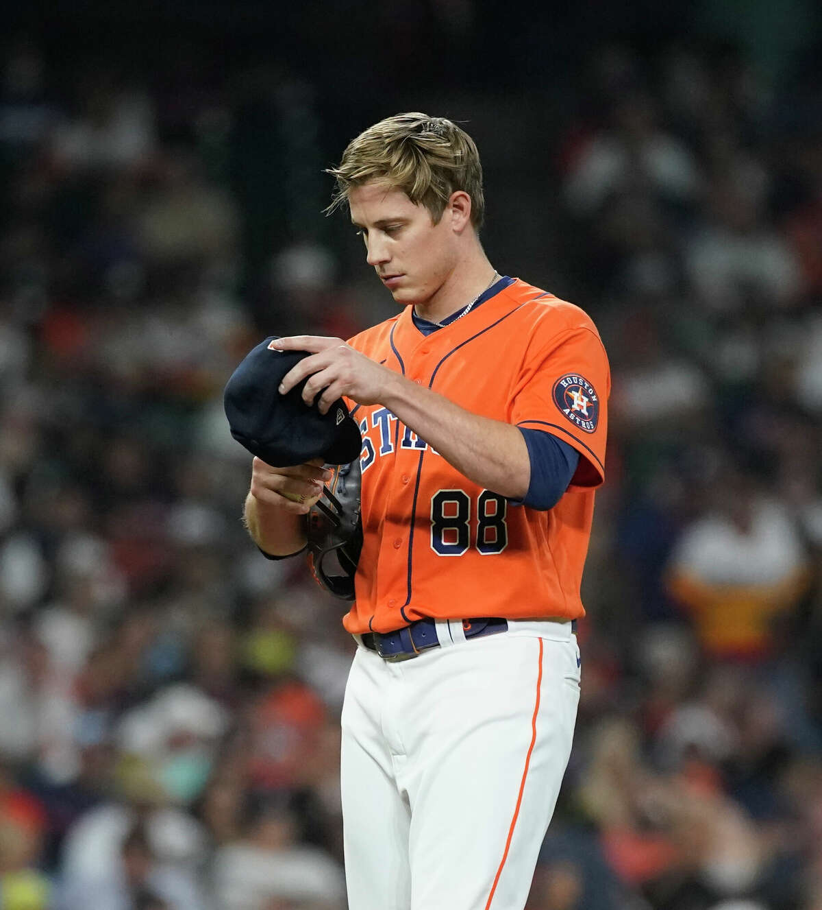 Houston Astros relief pitcher Phil Maton (88) adjusts his cap during the eighth inning of an MLB baseball game at Minute Maid Park on Friday, May 6, 2022 in Houston.
