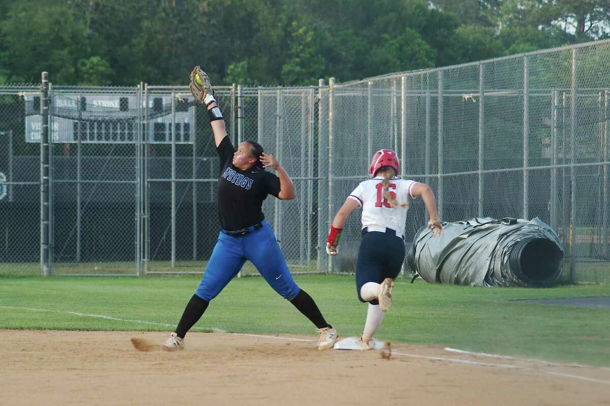 Clear Springs’ Anna Soles (20) reaches to make the catch and the out as Atascocita’s Raegan Jennings (16) sprints to beat the throw to first base Friday, May 6, 2022 at Clear Springs High School.