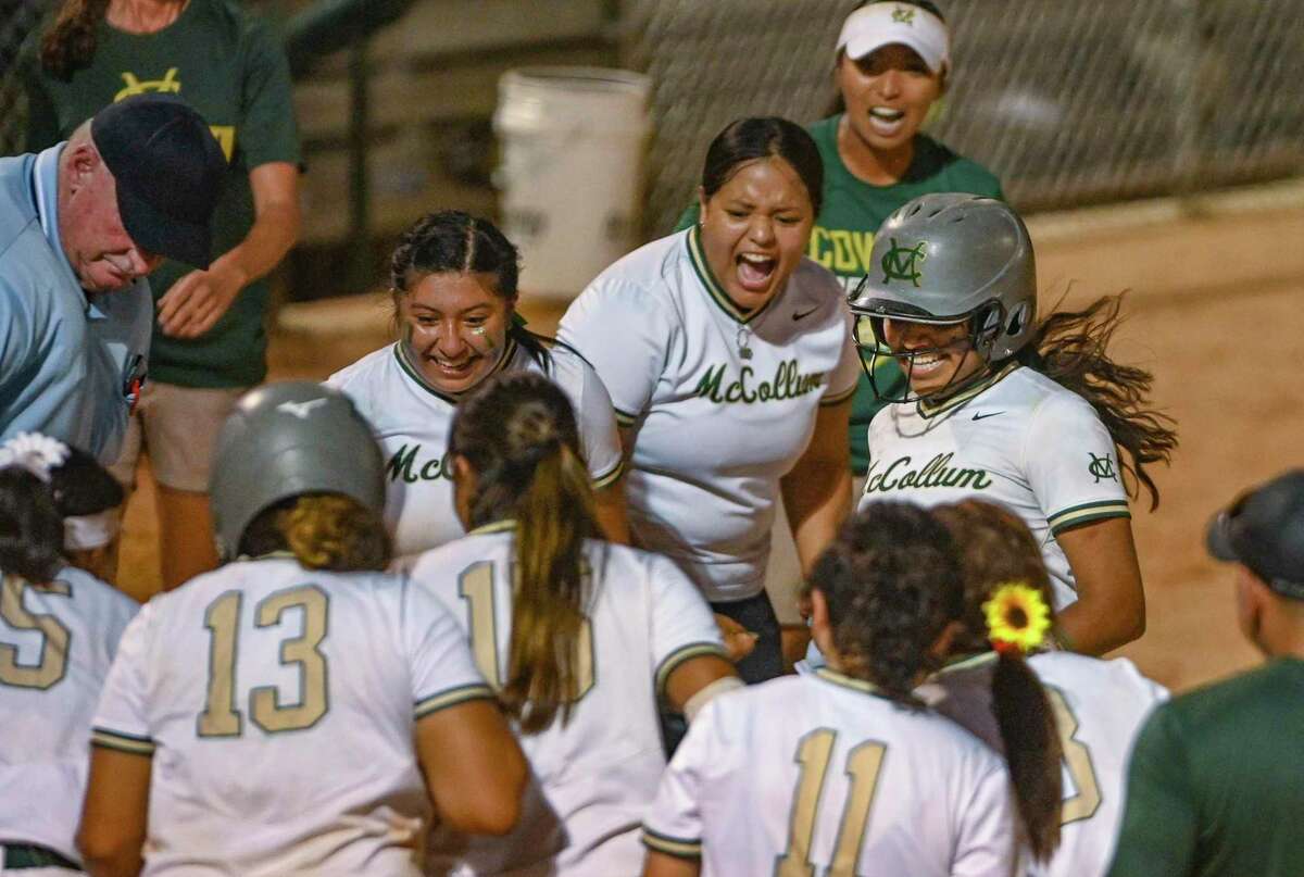 Rosalyn Rodriguez of McCollum is greeted at home plate by teammates after hitting a walk-off home run to defeat Boerne Champion, 5-2 in the Class 5A softball area championship game at Northside Field on Friday, May 6, 2022. McCollum won in 11 innings, 5-2.