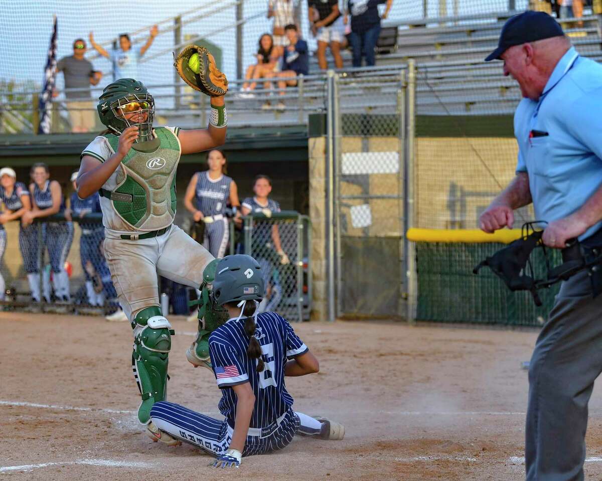 McCollum catcher America Ramirez shows the ball to the umpire after she tagged out Madison Hall (6) of Boerne Champion during the Class 5A softball area championship game at Northside Field on Friday, May 6, 2022. McCollum won in 11 innings, 5-2.