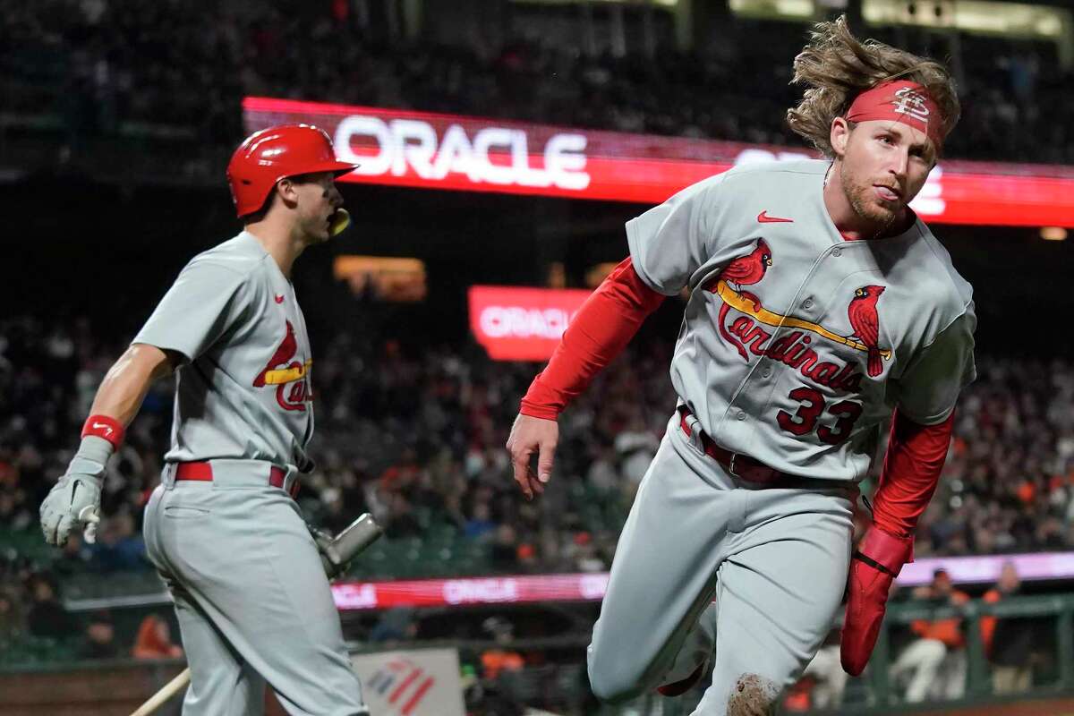 St. Louis Cardinals' Brendan Donovan, right, runs to the dugout after being congratulated by Andrew Knizner for scoring against the San Francisco Giants during the ninth inning of a baseball game in San Francisco, Friday, May 6, 2022. (AP Photo/Jeff Chiu)
