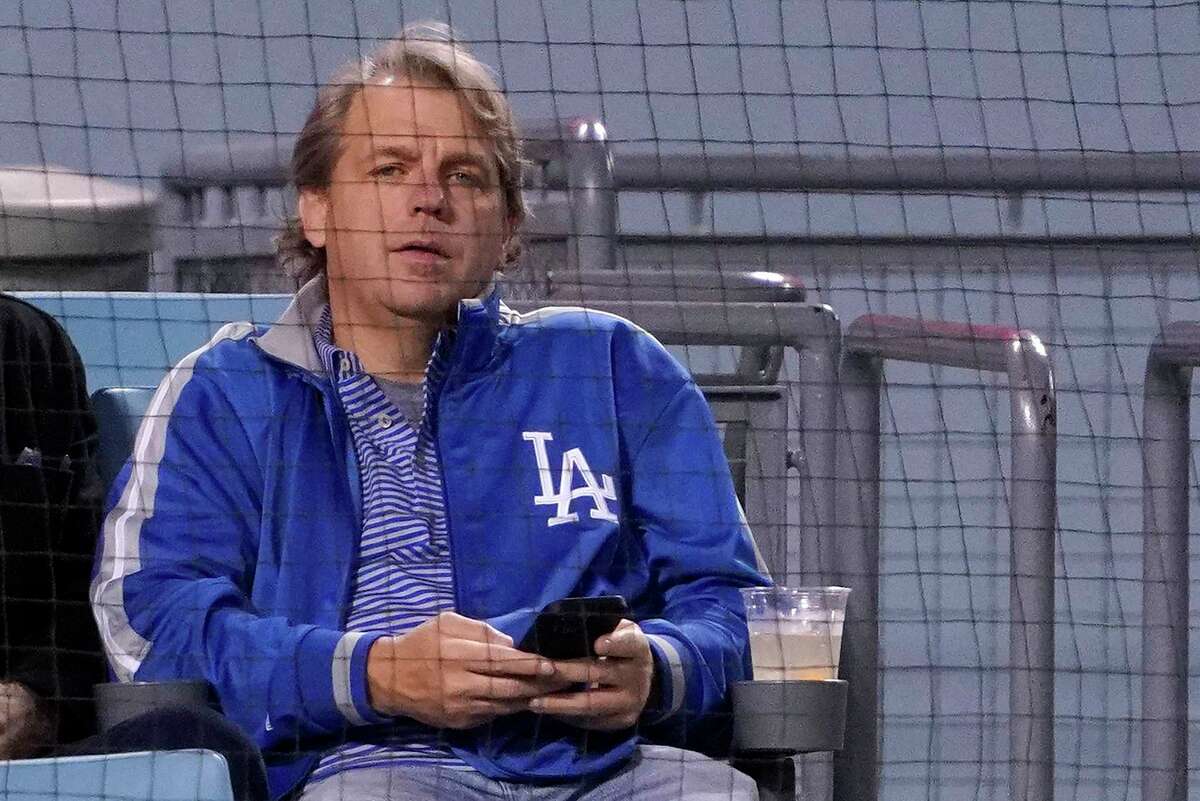 FILE - Los Angeles Dodgers co-owner Todd Boehly watches a baseball game against the Detroit Tigers Saturday, April 30, 2022, in Los Angeles. Chelsea is being sold to a consortium fronted by American sports investor Todd Boehly. It ends 19 years of ownership and lavish investment by Roman Abramovich until the Russian oligarch was sanctioned and forced to offload the Premier League club. The deal is worth 4.25 billion pounds ($5.24 billion).