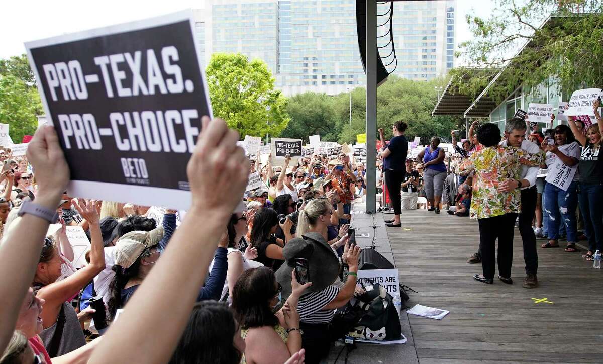 Beto O’Rourke hugs Sheila Jackson Lee on stage in front of a large crowd during an abortion rights rally organized by Beto O’Rourke at Discovery Green on Saturday, May 7, 2022 in Houston.