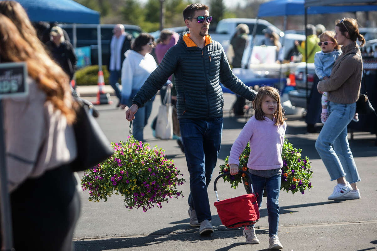 Visitors check out a wide variety of vendors on the opening day of the Midland Farmers Market Saturday, May 7, 2022 at Dow Diamond.