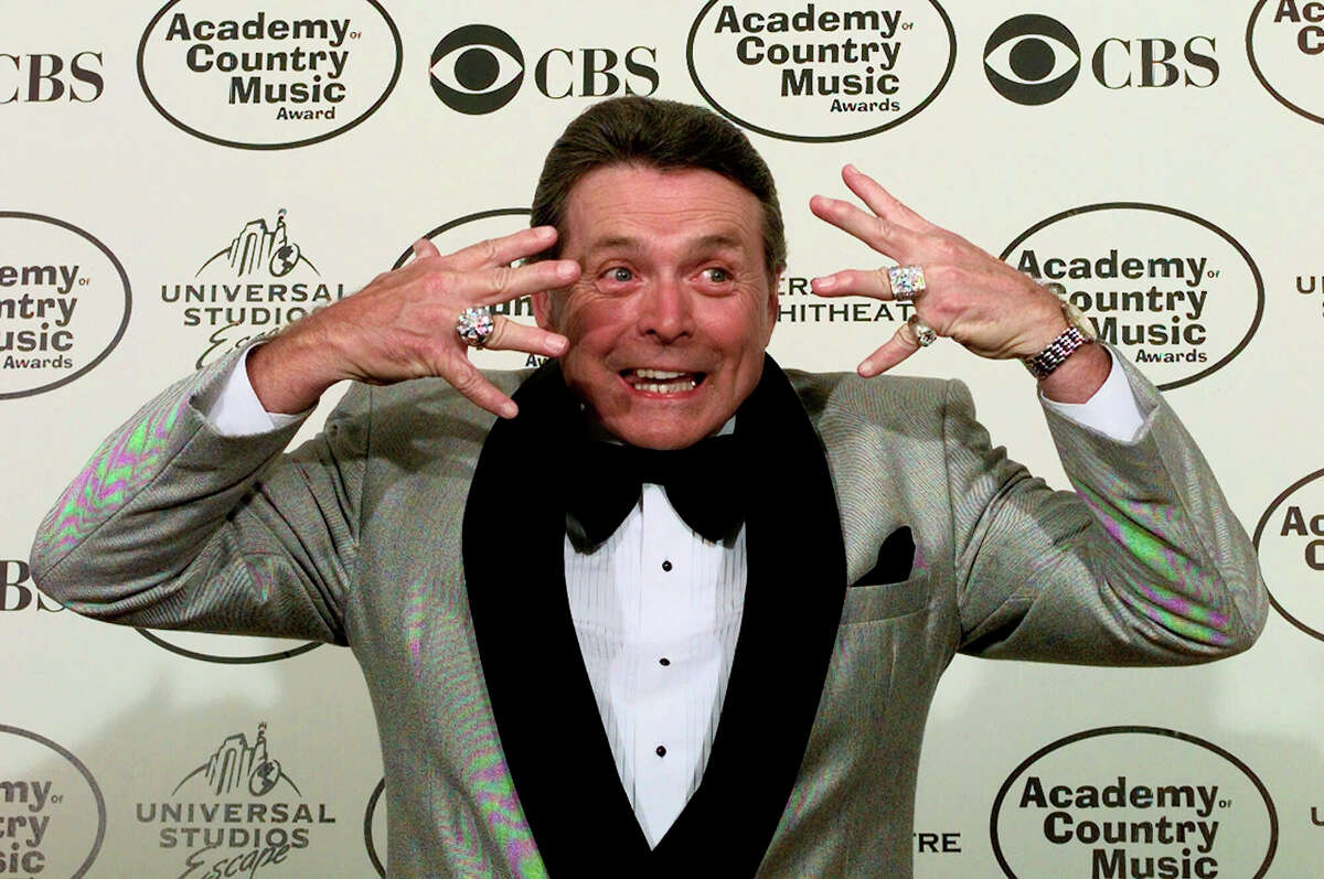 FILE - Presenter Mickey Gilley shows off his diamond rings to the media during the 34th Annual Academy of Country Music Awards in Universal City, Calif., on Wednesday, May 5, 1999. Gilley, whose namesake Texas honky-tonk inspired the 1980 film “Urban Cowboy,” and a nationwide wave of Western-themed nightspots, died Saturday, May 7, 2022, at age 86.
