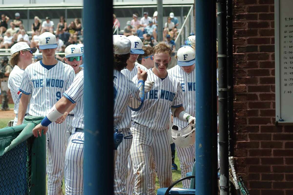 Friendswood’s Dylan Maxcey (1) is congratulated by teammates after hitting a home run against Nederland Saturday, May 7, 2022 at Friendswood High School.