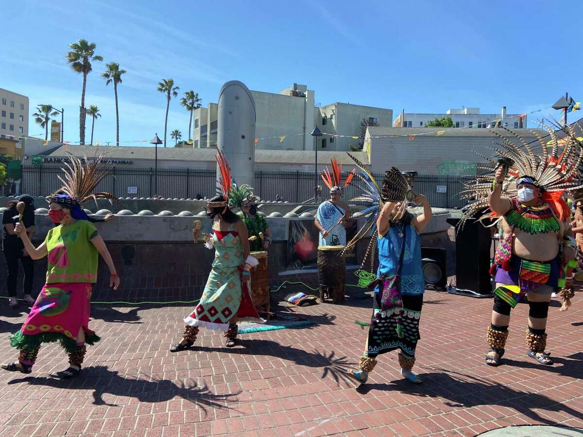 Danza Xitlalli performs a traditional native Mexican prayer dance at the launch of the Calle 24 Latino Cultural District's Calle Limpia, Corazón Contento economic recovery program on Saturday, May 5, 2022.