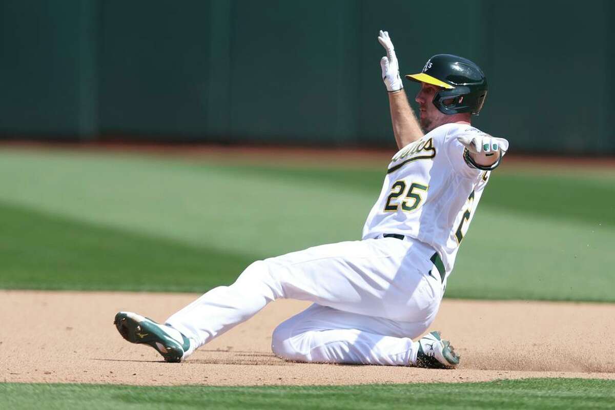Oakland Athletics' Stephen Piscotty slides into second base against the Texas Rangers during a baseball game in Oakland, Calif., Saturday, April 23, 2022. (AP Photo/Jed Jacobsohn)